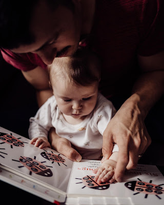 In home lifestyle Family imagery of Father and Daughter reading book together photogrpahed by Morning Owl Fine Art Photography San Diego. 