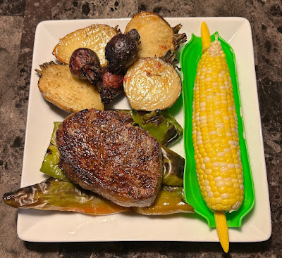 Rare grilled prime ribeye eye, with fire roasted hatch chiles, oven roasted beets and corn on the cob