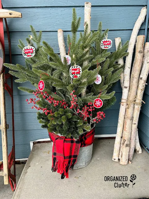 Photo of galvanized bucket Christmas Porch Pot with faux greenery.