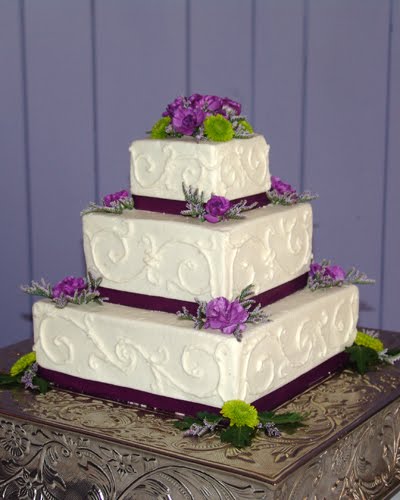  ribbon and purple and green flowers Four tier white textured wedding 