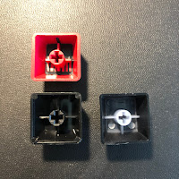 The undersides of the two wasd keycaps (left) and an OEM keycap from a GMMK keyboard for comparison