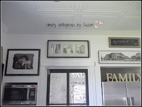 Black and white artwork wall in kitchen