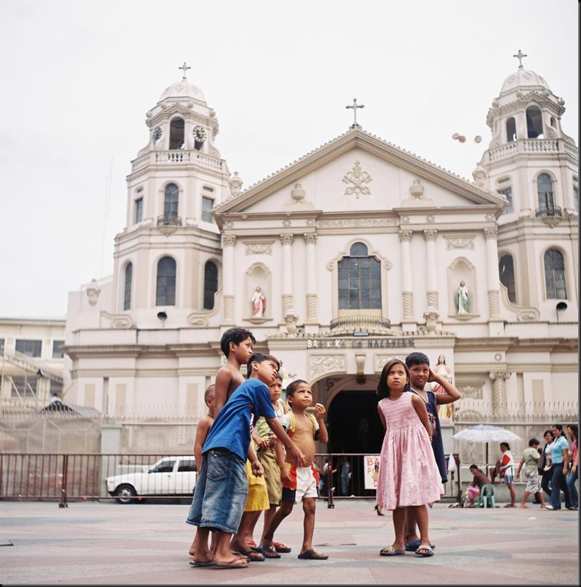 Street children play at the church facade in Quiapo, Manila on a slow day while their parents sell various goods and novelty items to tourists and churchgoers. They help out their parents during busy days.