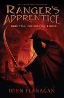 the cover of The Burning Bridge by John Flanagan book two in the ranger's apprentice series shows a cloaked boy with a drawn boy with a bridge on fire behind him