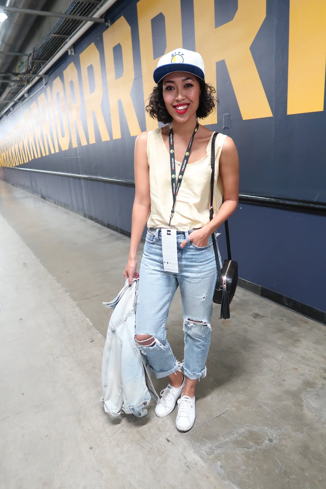 What to wear to a Warriors Game: Distressed Jeans, team colors, and a snapback cap.