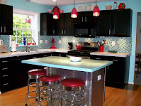 Kitchen island as bar features red stools