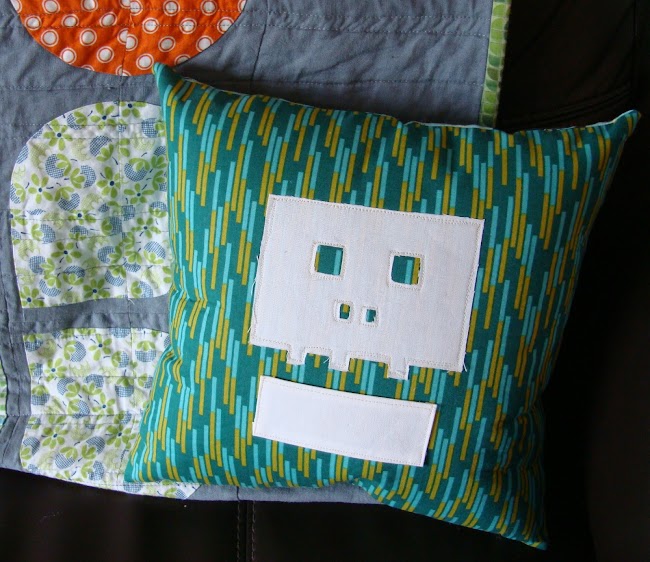 green cushion with white skull applique shape