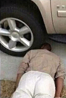 HEAD IN FRONT OF CAR'S WHEEL SUICIDE