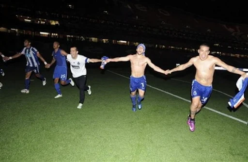 FC Porto players celebrate in the dark after the stadium lights were turned off