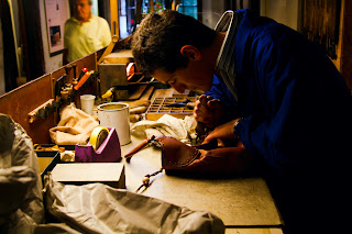 A Leather craftsman engraves a handbag - Firenze, Italy