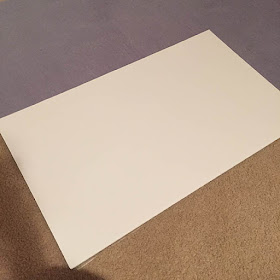 Gluing a white foam core board to the back of a large puzzle