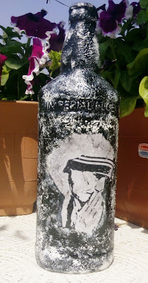 This recyled bottle has image of Mother Teresa decoupaged on it and the textured created with gesso and acrylic color. 