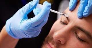 Man receiving Botox treatment in forehead at Beautox Bar Medspa Maple Grove