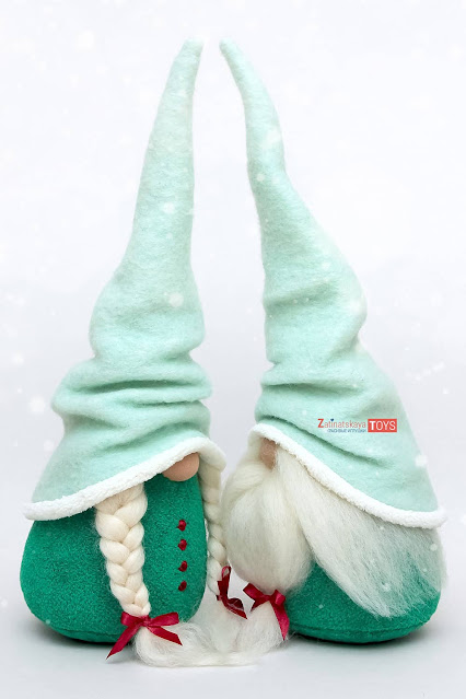 two plush Christmas gnomes with Scandinavian felt hats by sewing patterns of Zatinatskaya Natalia