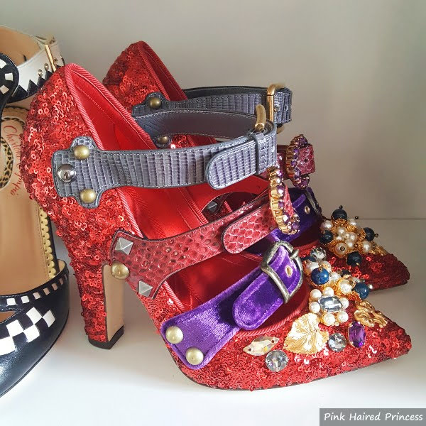 pair of red sequins designer shoes on shoe shelf with multiple straps