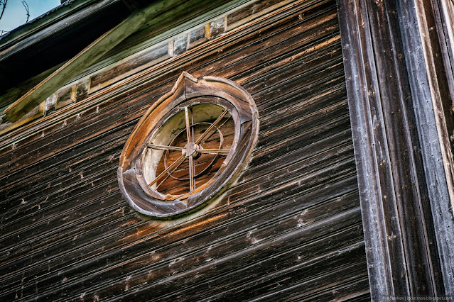 Круглое окно в деревянной стене