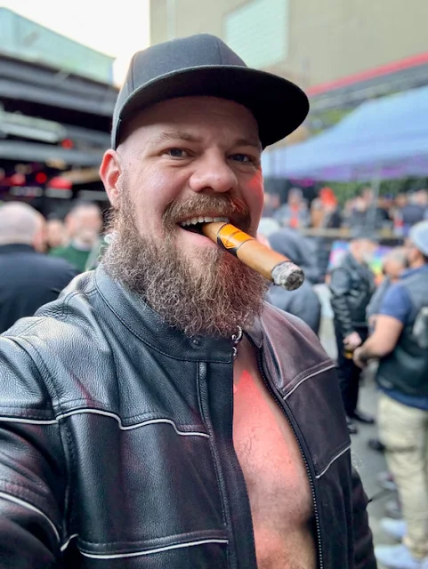 Big smiling pogonophiIiac lovers cigar smoking dude wearing black leather jacket