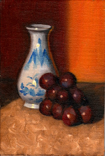 Oil painting of a miniature white and blue porcelain vase beside a small bunch of red grapes.