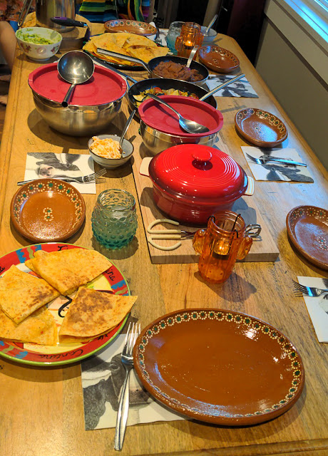 A table full of vegan versions of Mexican food including tacos, quesadillas, and salads.