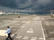 Walking and driving across the airport runway. (runway)