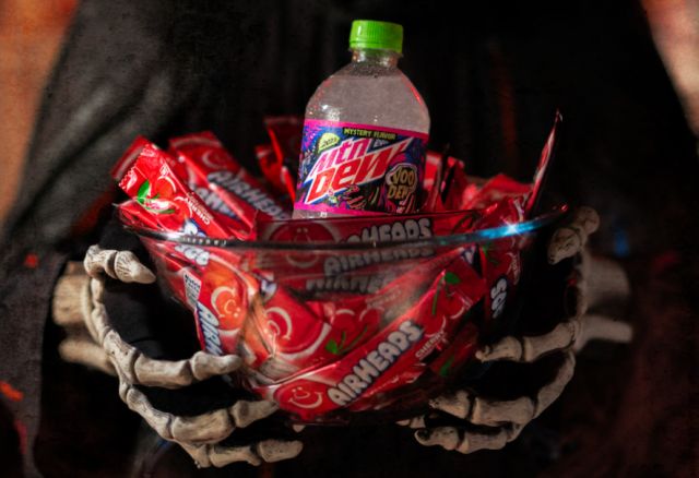 2023 Mtn Dew Voo-Dew bottle in a bowl of Cherry Airhead candies.