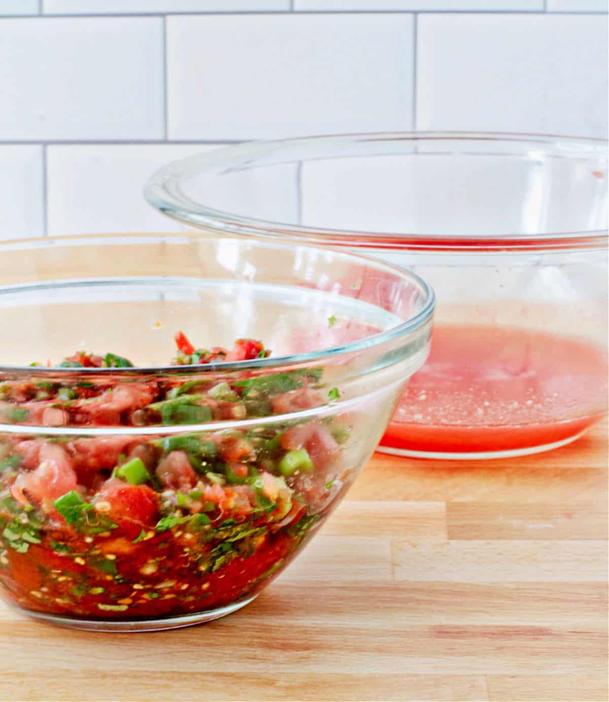 Bowl of Fresh Tomato Salsa, with the drained juices in the background