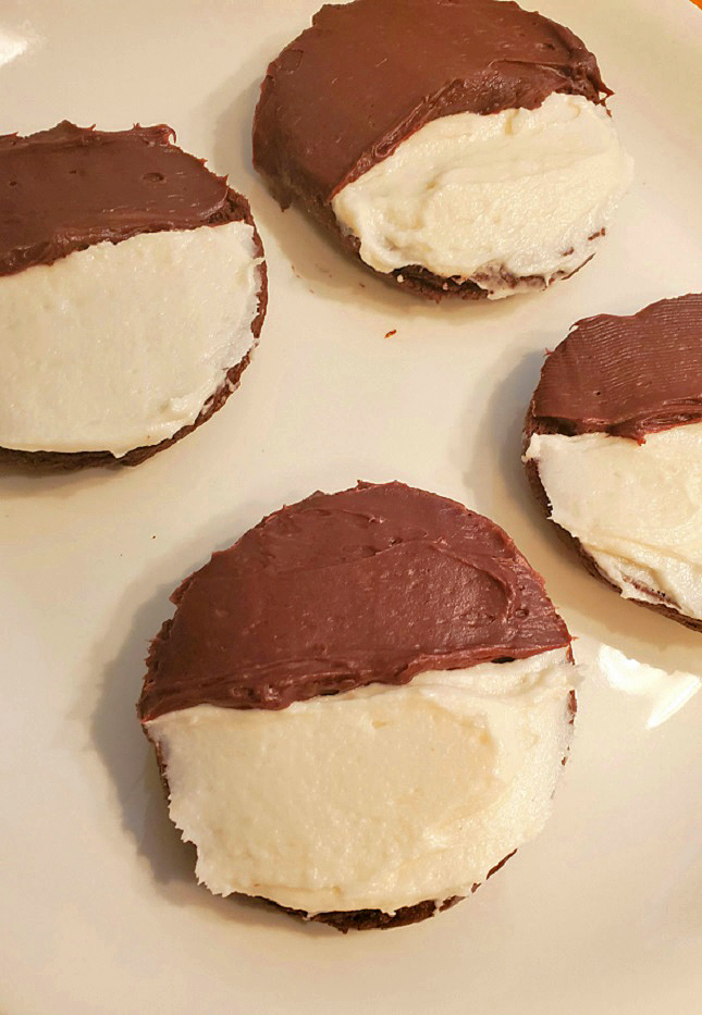 these are half moon cookies made with a chocolate cake mix frosted also called black and white cookies