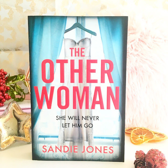 The Other Woman book in front of candles, autumn props