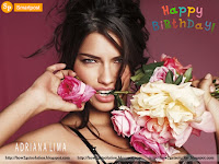 adriana lima hot photo birthday celebration, she is smiling along holding pink rose in her teeth