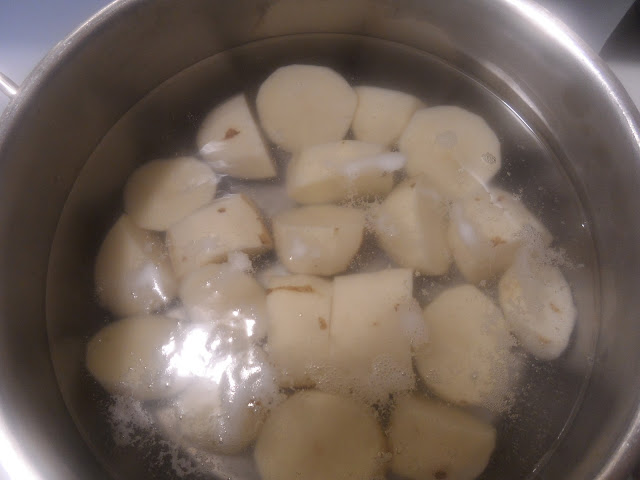 potatoes cut into thirds and boiling