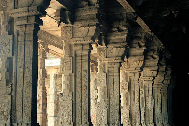 The elegantly carved colossal monolithic stone columns inside the temple