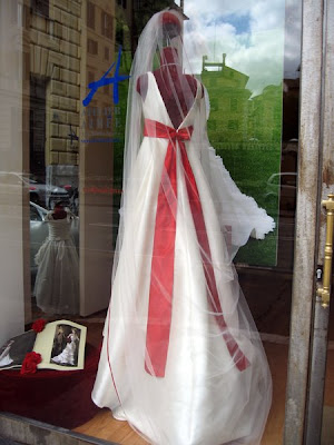 Wedding dress with red sash.