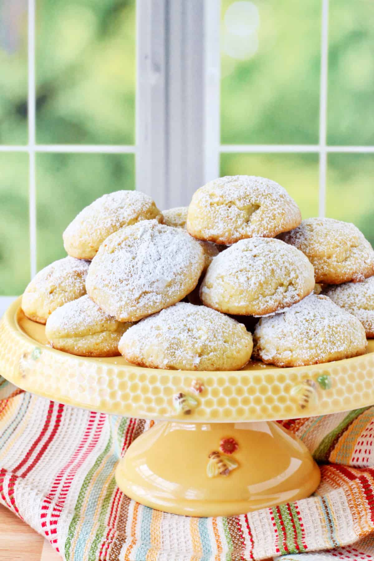 Orange Polvorones on a bee cake stand.