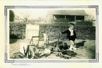 Thurber child, Meredith Sides posing with his collection of toys  O. M. Sides Collection