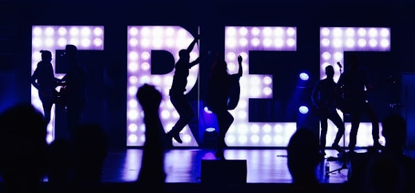 Image: Silhouette of people with a giant FREE light up behind them | Photo by William White on Unsplash