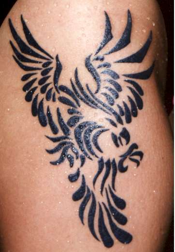 This guy also wearing a cross and flame tattoo on his left forearm Tribal
