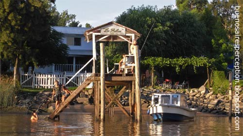 Swimming at a landing stage in the Río Sarmiento, a branch of the Río Paraná Delta in Tigre