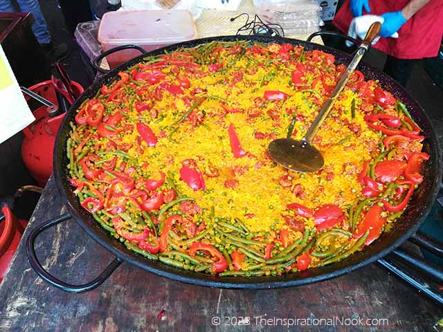 Chorizo paella cooked uncovered with chorizo sausage, red peppers and green beans.
