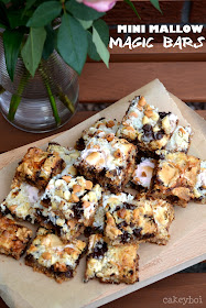 Magic bars - biscuit base, topped with walnuts, chocolate chunks, white chocolate chips, butterscotch bits, desiccated coconut, condensed milk and mini marshmallows.