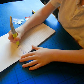 6 year old right handed boy writing with shaped pen