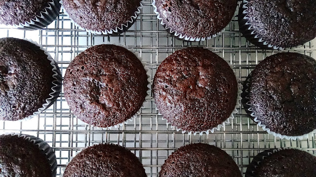 baked gluten free chocolate cupcakes cooling on a wire rack