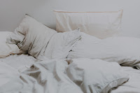 Photo of a bed with extremely rumpled bedding