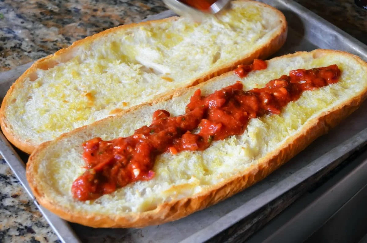 Toasted French Bread with Pizza Sauce on top for French Bread Pizza.