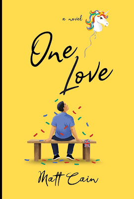 The cover of One Love by Matt Cain  shows a man from behind sitting on a park bench with colorful confetti raining down around  him.