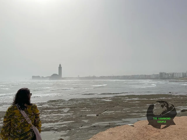 Casablanca shoreline and skyline from Cabano Beach: Hassan II Mosque in distance, Morocco, Africa