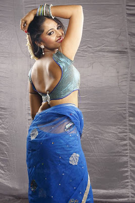 Anuskha Shetty in blue blouse & netted saree, showing her back side.