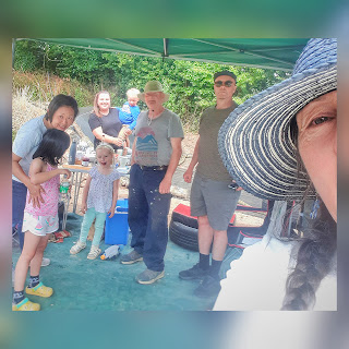 Family picnic group selfie, raggletaggle of people some of whom are looking the right way