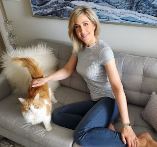 Anne Drewa sitting in a sofa with a cat