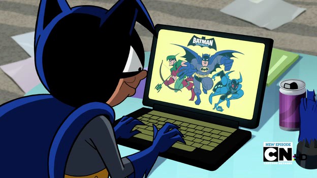 Bat-Mite sitting at a laptop with 'Batman: The Brave and the Bold' on the screen