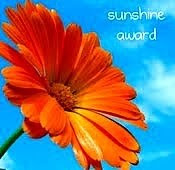 Sunshine award - has a pretty flower in the background